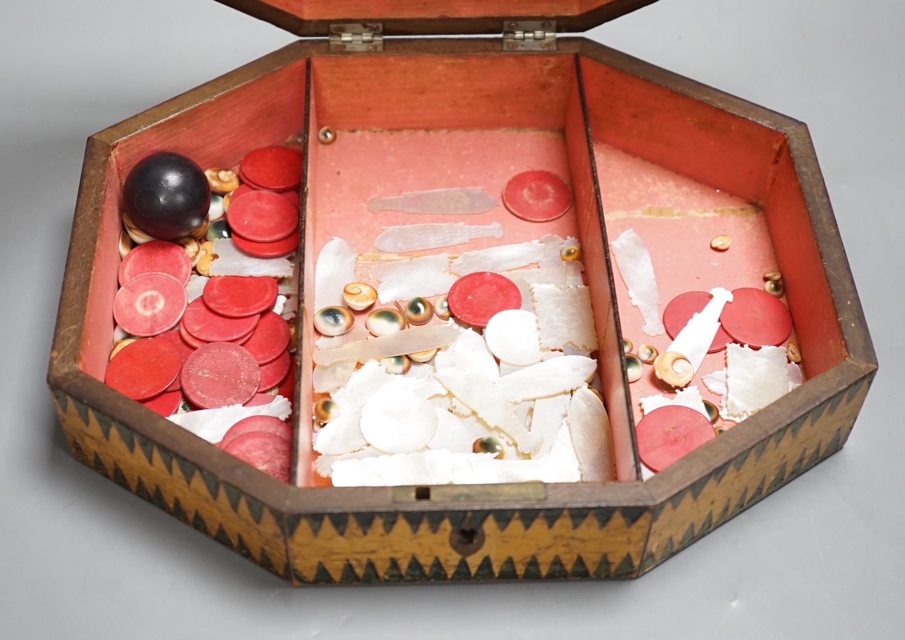 A Regency octagonal painted sycamore work box, containing mother of pearl and bone counters 26cm